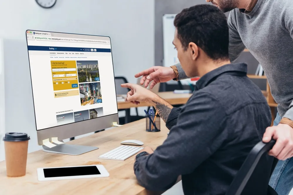 Two colleagues reviewing a law firm website on a desktop computer