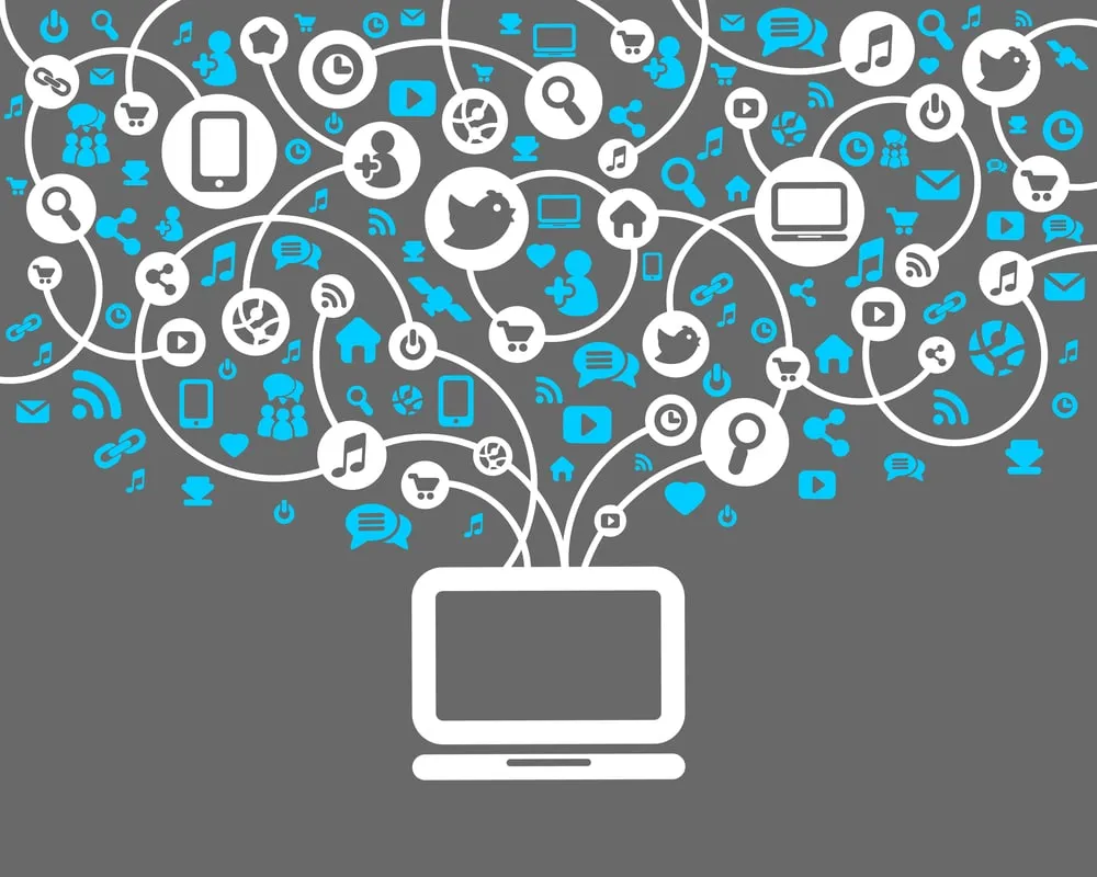 Laptop surrounded by icons for social media, apps and online services