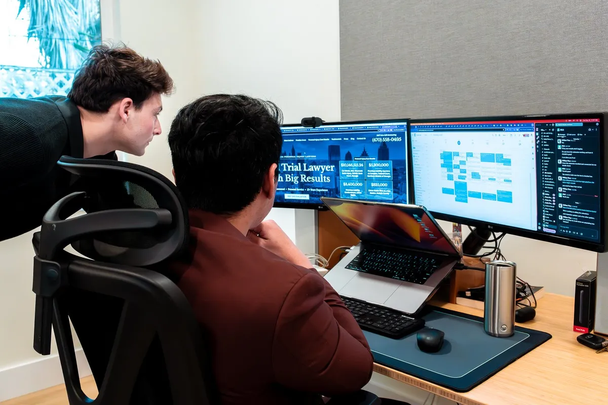 Matador team members reviewing a law firm's site on two monitors